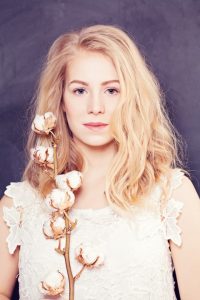 Woman with long blond curly hair